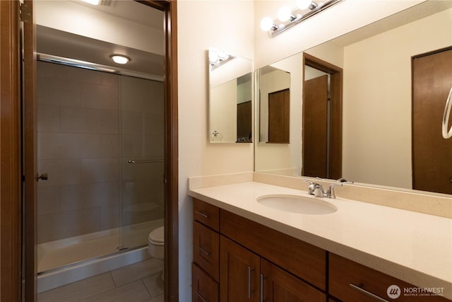 3421 SW Roxbury St Unit 106, Seattle, WA 98126 - full bath featuring toilet, tile patterned floors, a stall shower, and vanity