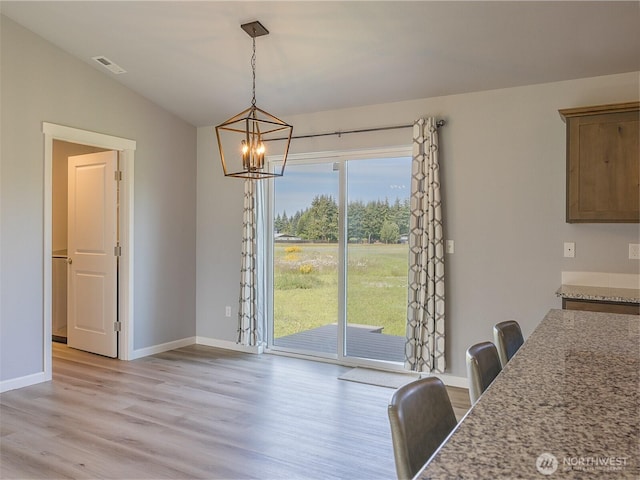 41 Kates Ct, Port Angeles, WA 98362 - dining space featuring a chandelier, light wood-type flooring, lofted ceiling, and baseboards
