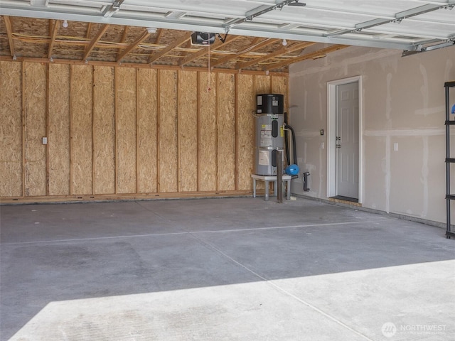 41 Kates Ct, Port Angeles, WA 98362 - garage with hybrid water heater and a garage door opener