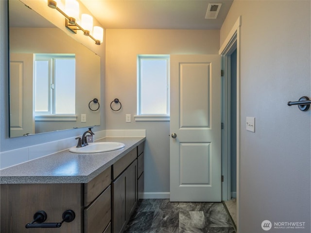 41 Kates Ct, Port Angeles, WA 98362 - bathroom featuring vanity, marble look tiles, and baseboards