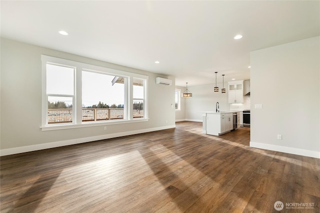 5942LOT47 Ranch Loop, Ferndale, WA 98248 - unfurnished living room with a wall mounted AC, dark wood-style flooring, baseboards, and recessed lighting