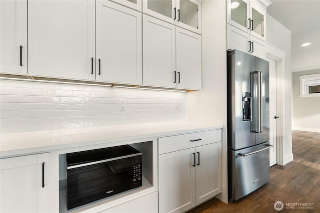 5942LOT47 Ranch Loop, Ferndale, WA 98248 - kitchen featuring high end refrigerator, black microwave, dark wood-type flooring, backsplash, and white cabinetry