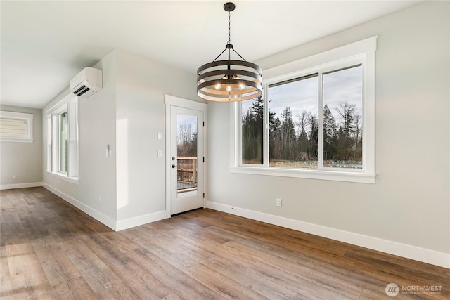 5942LOT47 Ranch Loop, Ferndale, WA 98248 - unfurnished dining area with a wall mounted air conditioner, a chandelier, baseboards, and wood finished floors