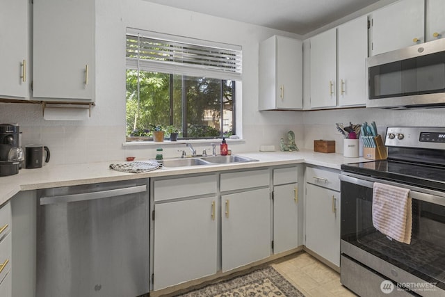2209 Mciver Ct SW, Tumwater, WA 98512 - kitchen featuring appliances with stainless steel finishes, decorative backsplash, a sink, and light countertops
