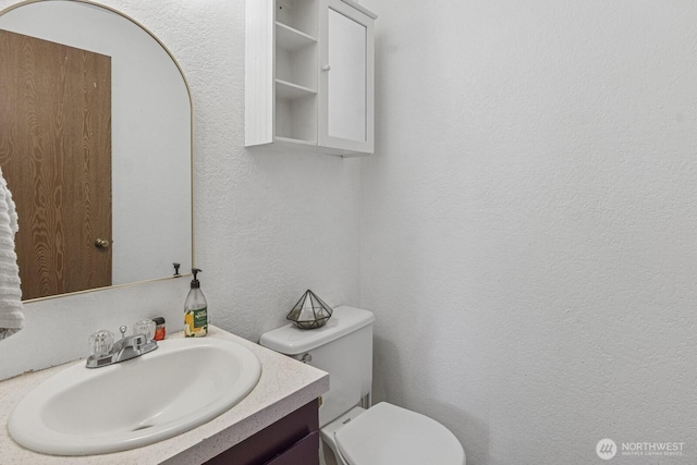 2209 Mciver Ct SW, Tumwater, WA 98512 - half bath featuring toilet, vanity, and a textured wall