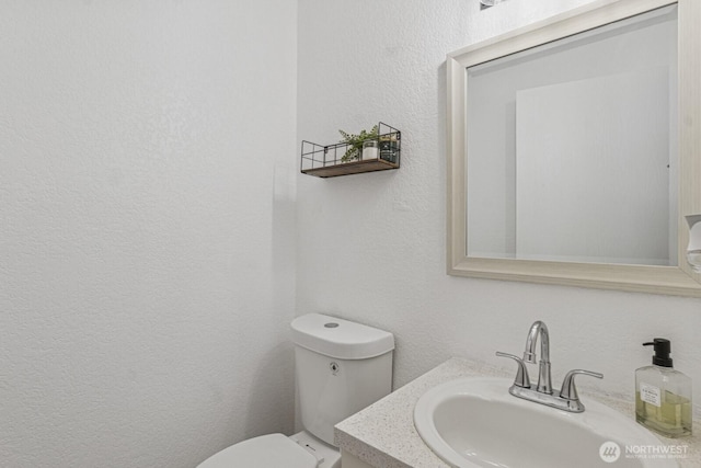 2209 Mciver Ct SW, Tumwater, WA 98512 - half bath featuring toilet, vanity, and a textured wall