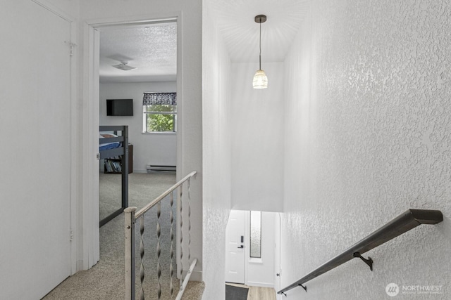2209 Mciver Ct SW, Tumwater, WA 98512 - stairs featuring a textured wall, baseboard heating, and carpet floors