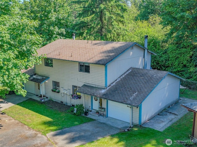 2209 Mciver Ct SW, Tumwater, WA 98512 - view of front of home featuring a front lawn, concrete driveway, an attached garage, a shingled roof, and a forest view