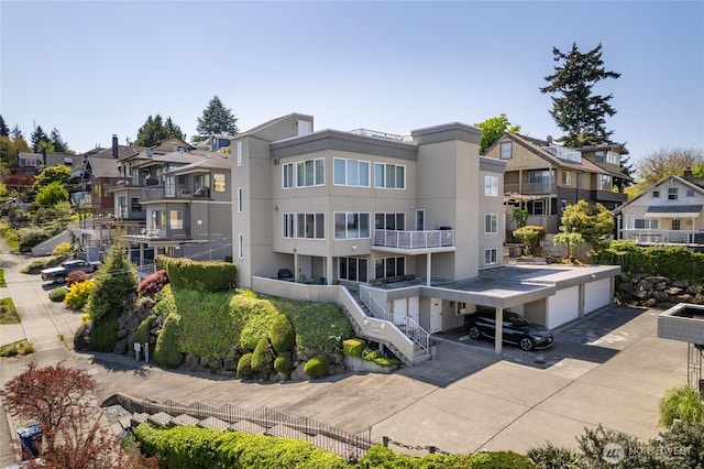 2627 Warren Ave N Unit 200, Seattle, WA 98109 - back of property featuring a residential view, stucco siding, and driveway