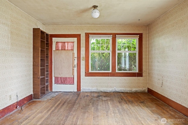 208 Carolina St, Bellingham, WA 98225 - empty room with wood-type flooring, wallpapered walls, and baseboards