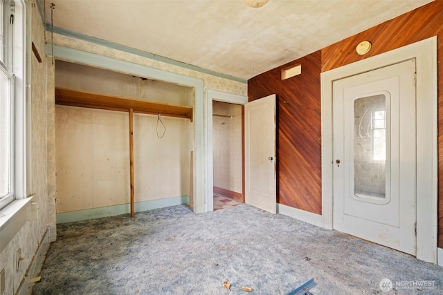 208 Carolina St, Bellingham, WA 98225 - unfurnished bedroom with carpet floors, a closet, and wood walls