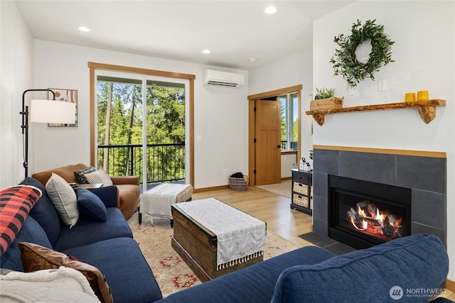 720 Stone Ridge Dr, Cle Elum, WA 98922 - living room featuring a wall unit AC, light wood-style floors, healthy amount of natural light, recessed lighting, and a tile fireplace