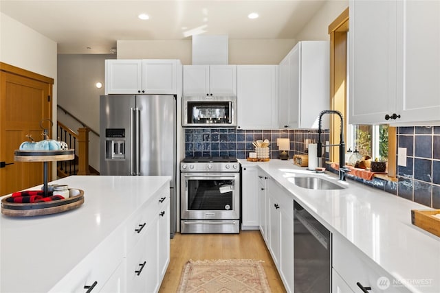 720 Stone Ridge Dr, Cle Elum, WA 98922 - kitchen featuring stainless steel appliances, a sink, light wood-type flooring, white cabinets, and recessed lighting