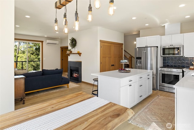 720 Stone Ridge Dr, Cle Elum, WA 98922 - kitchen featuring appliances with stainless steel finishes, an AC wall unit, light wood-style floors, and recessed lighting