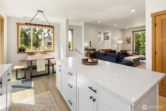 720 Stone Ridge Dr, Cle Elum, WA 98922 - kitchen with light wood-style floors, light countertops, white cabinetry, recessed lighting, and open floor plan