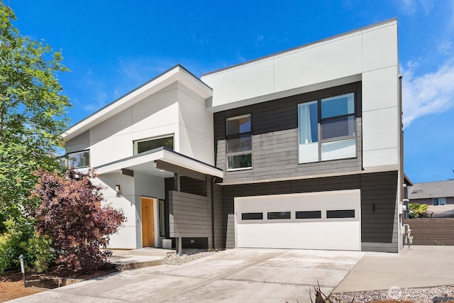 8622 NE 177th Pl, Bothell, WA 98011 - contemporary home with driveway, a garage, and stucco siding