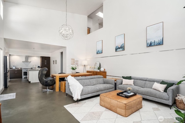 8622 NE 177th Pl, Bothell, WA 98011 - living room featuring a chandelier, concrete flooring, and a towering ceiling