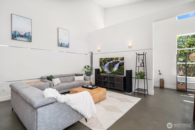 8622 NE 177th Pl, Bothell, WA 98011 - living area with finished concrete floors, baseboards, and a high ceiling