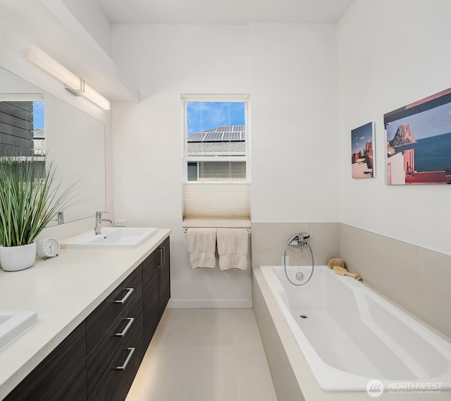 8622 NE 177th Pl, Bothell, WA 98011 - full bathroom featuring double vanity, a garden tub, and baseboards