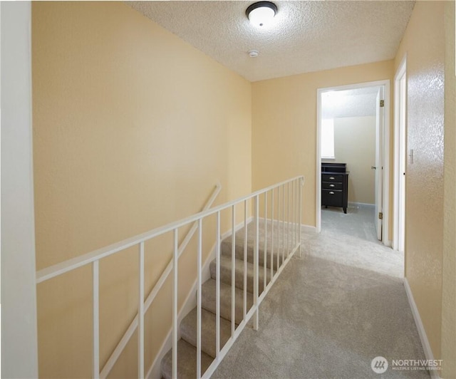 1421 W Casino Rd Unit A4, Everett, WA 98204 - corridor featuring a textured ceiling, an upstairs landing, and carpet
