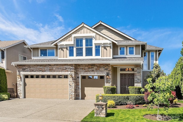 27528 SE 28th Ct, Sammamish, WA 98075 - view of front of house featuring board and batten siding, an attached garage, stone siding, and driveway