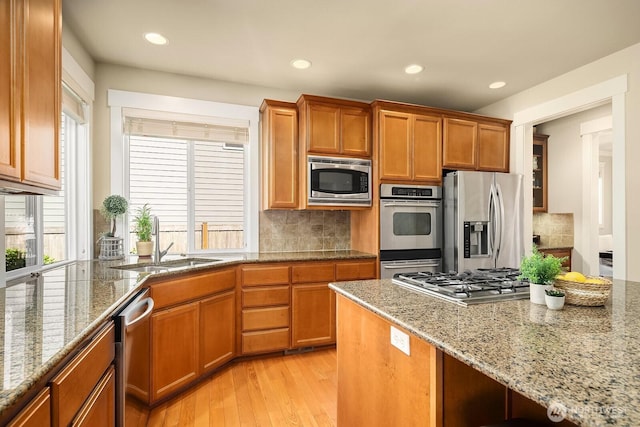 27528 SE 28th Ct, Sammamish, WA 98075 - kitchen with appliances with stainless steel finishes, light wood-style floors, a sink, tasteful backsplash, and recessed lighting