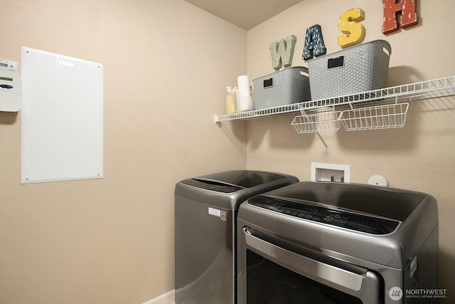 27528 SE 28th Ct, Sammamish, WA 98075 - laundry area featuring washer and clothes dryer and baseboards