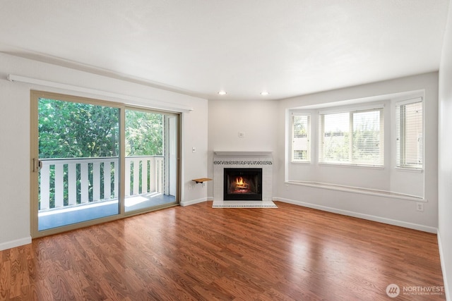18200 73rd Ave NE Unit B205, Kenmore, WA 98028 - unfurnished living room with wood finished floors, baseboards, a brick fireplace, and recessed lighting