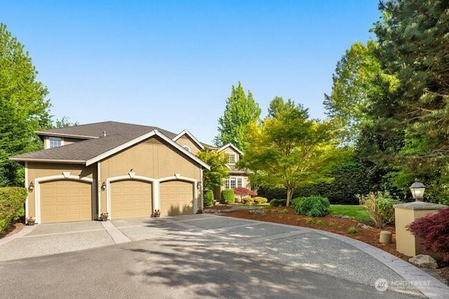 28816 118th Ave SE, Auburn, WA 98092 - view of front of house with an attached garage, driveway, and stucco siding