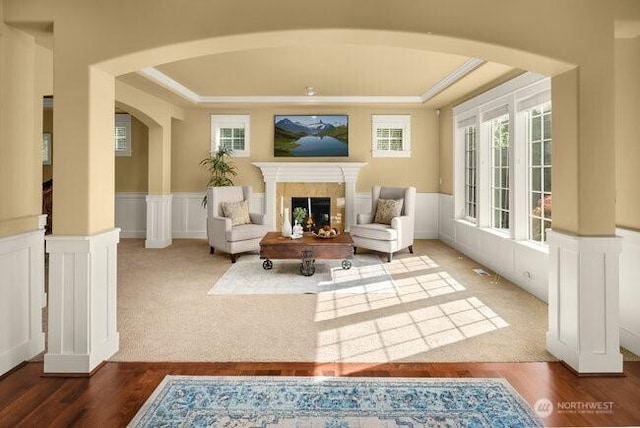 28816 118th Ave SE, Auburn, WA 98092 - sitting room with arched walkways, plenty of natural light, a tray ceiling, wood finished floors, and ornamental molding