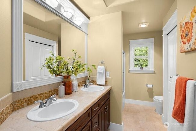 28816 118th Ave SE, Auburn, WA 98092 - full bathroom with double vanity, toilet,  shower combination, and baseboards