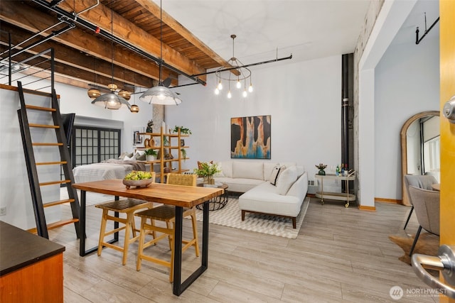 1505 11th Ave Unit 310, Seattle, WA 98122 - dining area with a chandelier, stairs, and light wood-style flooring