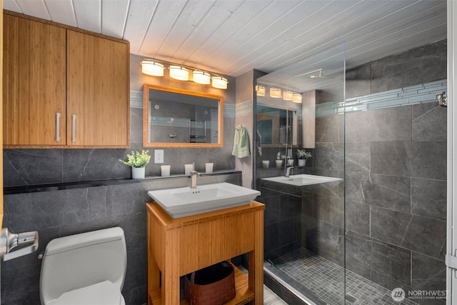 1505 11th Ave Unit 310, Seattle, WA 98122 - bathroom with tile walls, a shower stall, toilet, and vanity