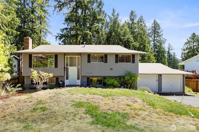 8539 University Point Cir NE, Bremerton, WA 98311 - raised ranch with a chimney, a garage, and roof with shingles