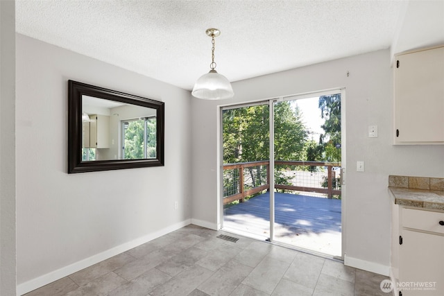 8539 University Point Cir NE, Bremerton, WA 98311 - unfurnished dining area featuring baseboards and a textured ceiling