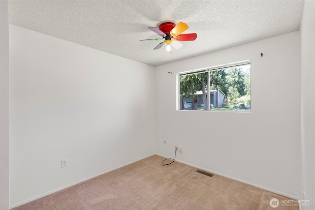 8539 University Point Cir NE, Bremerton, WA 98311 - unfurnished room featuring a ceiling fan, a textured ceiling, light colored carpet, and baseboards
