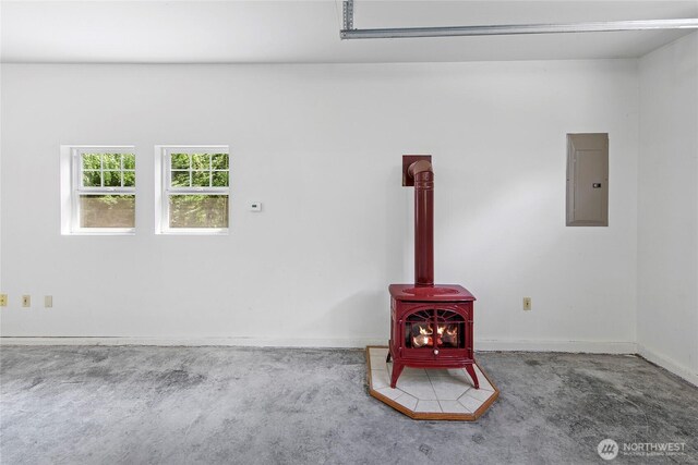 8000 NE W Port Madison Rd, Bainbridge Island, WA 98110 - garage with a wood stove, electric panel, and baseboards