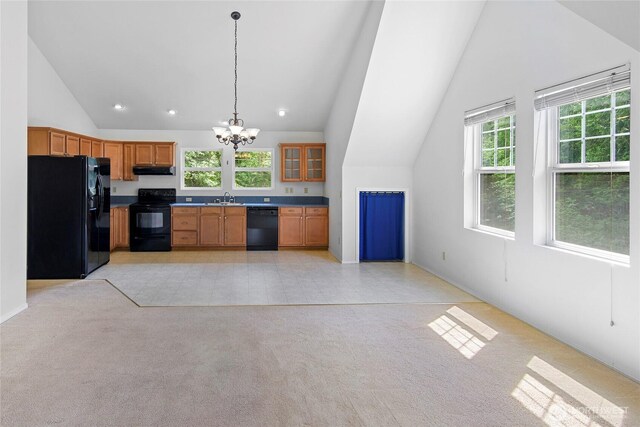 8000 NE W Port Madison Rd, Bainbridge Island, WA 98110 - kitchen featuring black appliances, vaulted ceiling, a sink, a chandelier, and exhaust hood