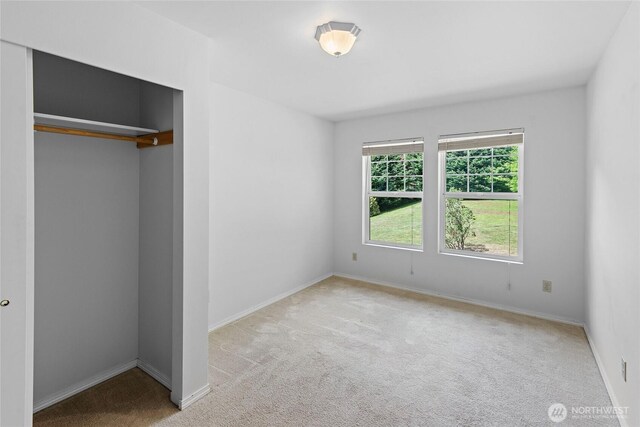 8000 NE W Port Madison Rd, Bainbridge Island, WA 98110 - unfurnished bedroom with carpet, baseboards, and a closet