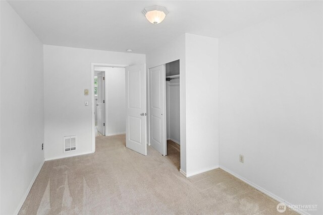 8000 NE W Port Madison Rd, Bainbridge Island, WA 98110 - unfurnished bedroom with light colored carpet, baseboards, and a closet