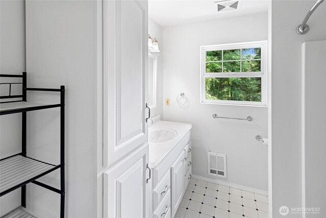 8000 NE W Port Madison Rd, Bainbridge Island, WA 98110 - bathroom featuring vanity, baseboards, and tile patterned floors
