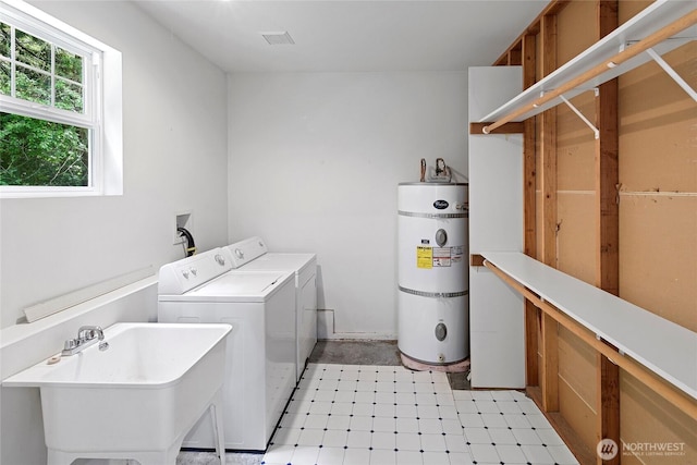 8000 NE W Port Madison Rd, Bainbridge Island, WA 98110 - laundry room featuring strapped water heater and washer and clothes dryer