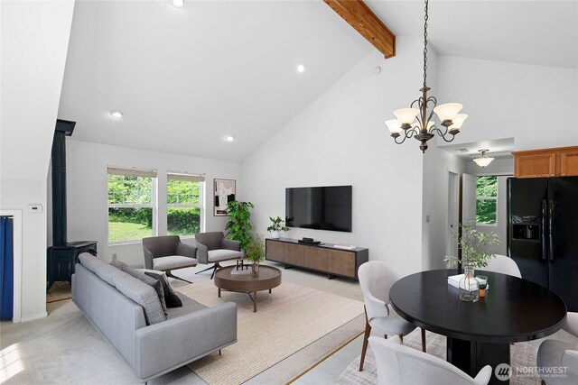 8000 NE W Port Madison Rd, Bainbridge Island, WA 98110 - living area featuring beam ceiling, high vaulted ceiling, a wood stove, plenty of natural light, and a chandelier