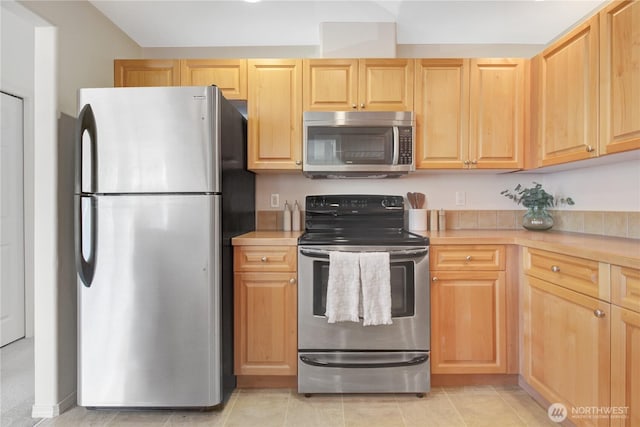 910 Medical Center Dr Unit E101, Arlington, WA 98223 - kitchen with stainless steel appliances, light countertops, light brown cabinetry, and light tile patterned floors