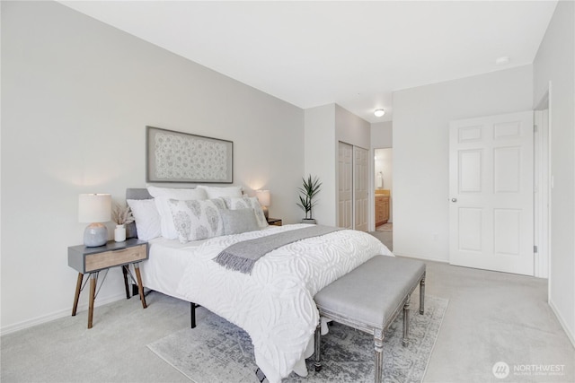 910 Medical Center Dr Unit E101, Arlington, WA 98223 - bedroom with light colored carpet, baseboards, and ensuite bathroom