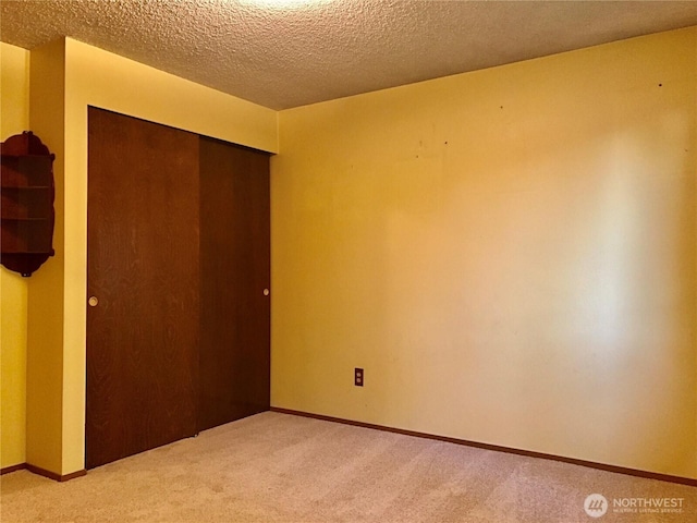 7613 12th Way, Olympia, WA 98516 - unfurnished bedroom with light colored carpet, a closet, a textured ceiling, and baseboards