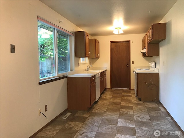 7613 12th Way, Olympia, WA 98516 - kitchen with white appliances, a sink, light countertops, under cabinet range hood, and stone finish floors
