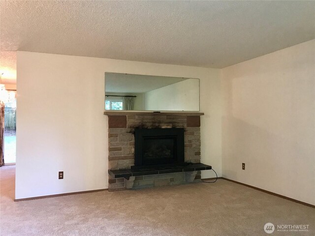 7613 12th Way, Olympia, WA 98516 - living area with a stone fireplace, carpet floors, a textured ceiling, and baseboards
