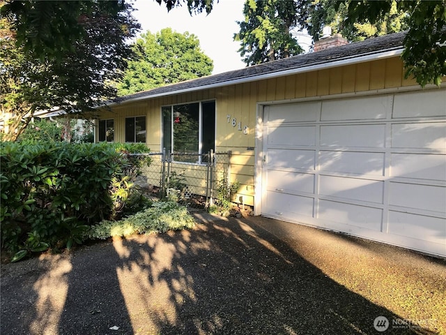 7613 12th Way, Olympia, WA 98516 - single story home featuring a shingled roof, a chimney, and an attached garage