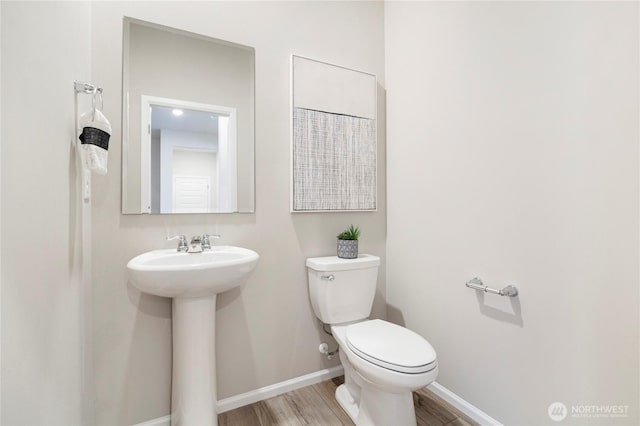 3266 SW Pier Ln, Port Orchard, WA 98367 - half bathroom featuring toilet, wood finished floors, a sink, and baseboards